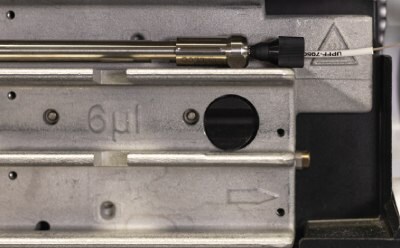 Zoomed-in picture of the Supelco® analytical HPLC column connected properly to the inlet tubing of Agilent® 1290 U/HPLC instrument.