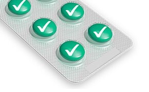 Six green pills with large check-marks in grey packaging.