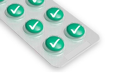 A blister pack of green pills, each marked with a white check mark, indicating they are approved or verified.