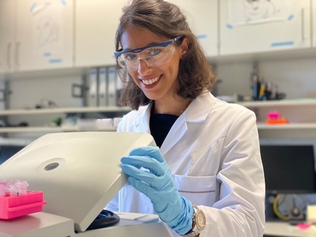 Lang looks at camera while working in the lab.