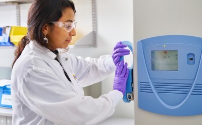 Female scientist closing the -80C freezer door.